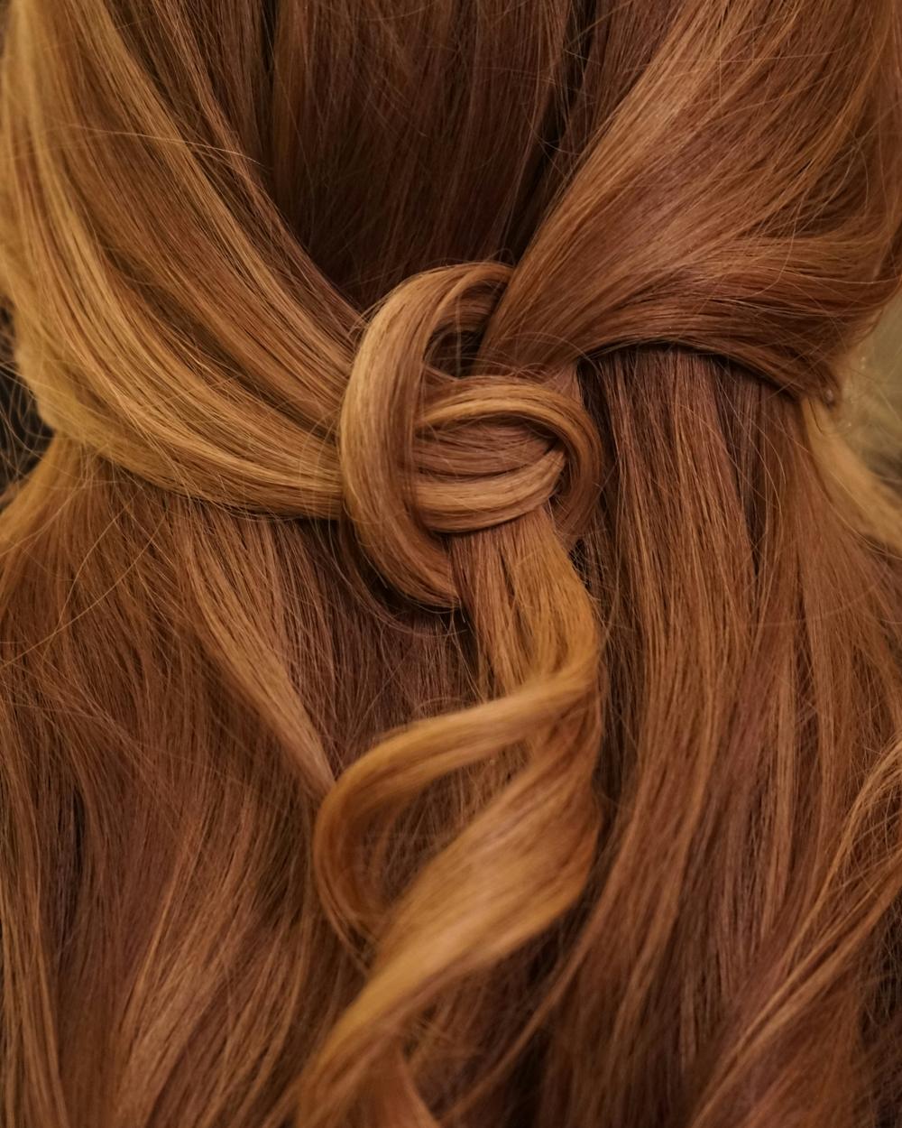 Copper red, deepest at the root, warming to burnished ginger through the mid lengths.